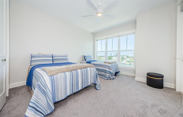 carpeted bedroom featuring vaulted ceiling and ceiling fan