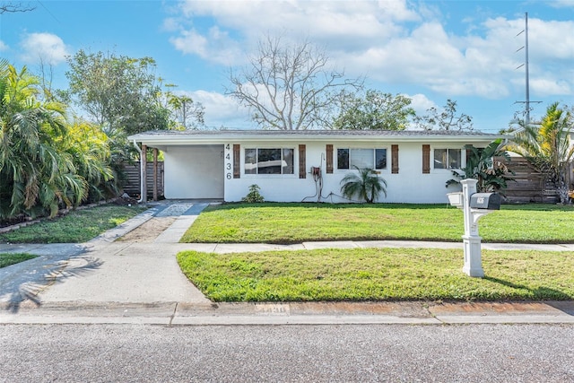 ranch-style house featuring a carport and a front yard