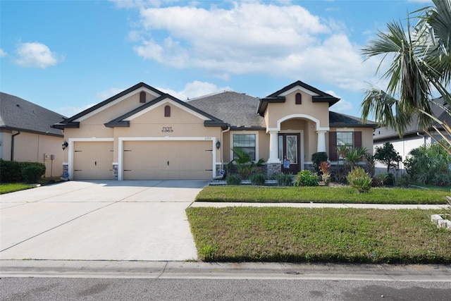 view of front of house featuring a garage and a front yard