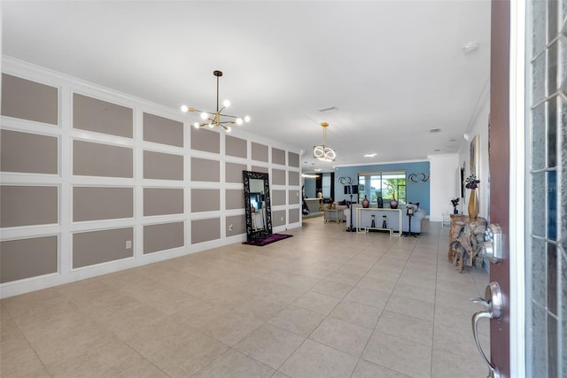 interior space with crown molding and a notable chandelier