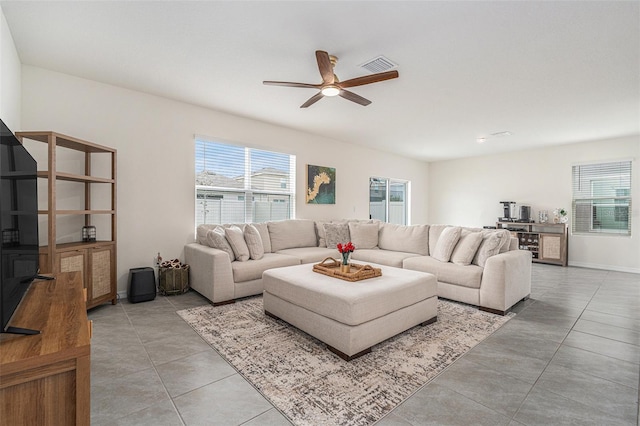 living room with visible vents, ceiling fan, baseboards, and light tile patterned floors