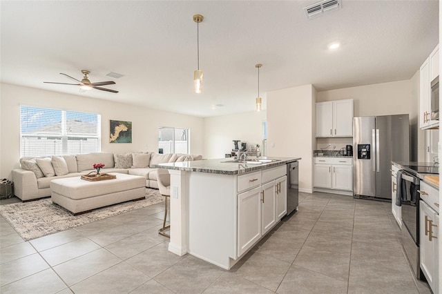 kitchen with open floor plan, stainless steel appliances, a sink, and visible vents