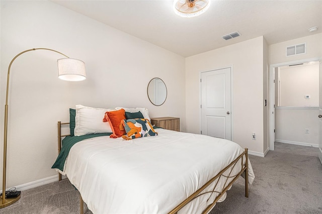 carpeted bedroom featuring baseboards and visible vents