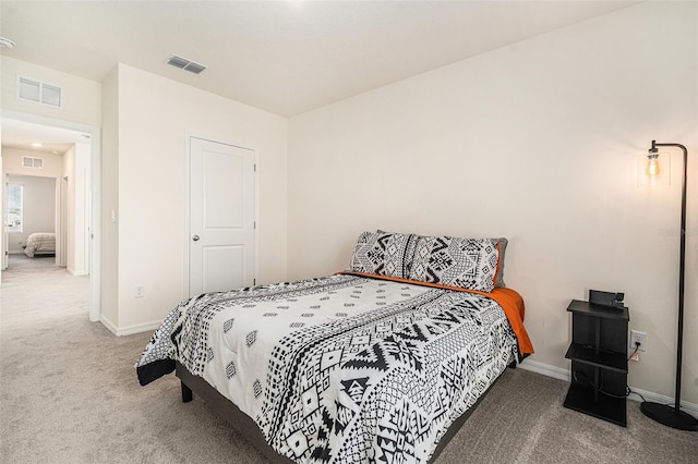 carpeted bedroom featuring visible vents and baseboards