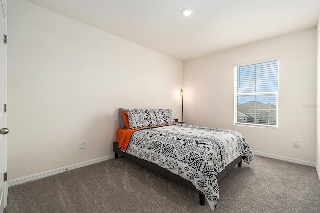 bedroom featuring carpet flooring and baseboards