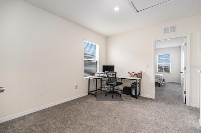 office space featuring carpet, visible vents, and baseboards