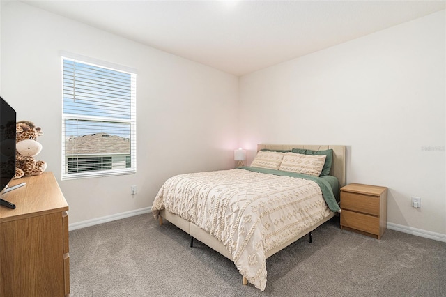 bedroom featuring light carpet and baseboards