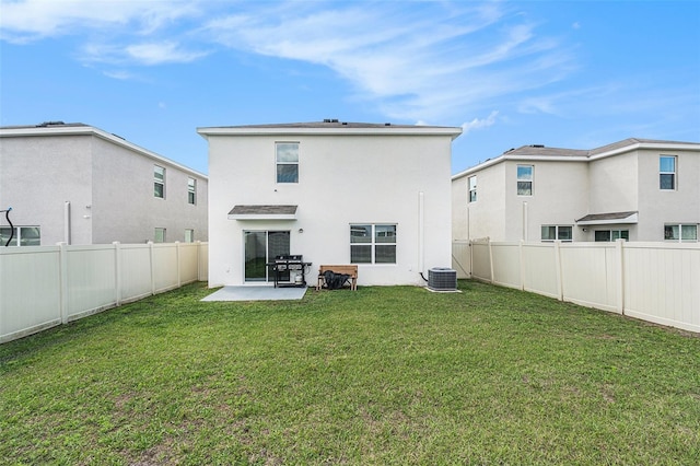 back of property with a patio, cooling unit, a fenced backyard, a lawn, and stucco siding