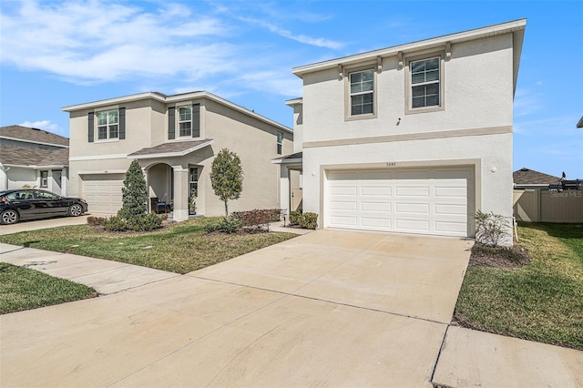 traditional home with concrete driveway, fence, an attached garage, and stucco siding