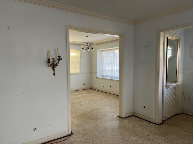 empty room featuring baseboards, ornamental molding, and an inviting chandelier