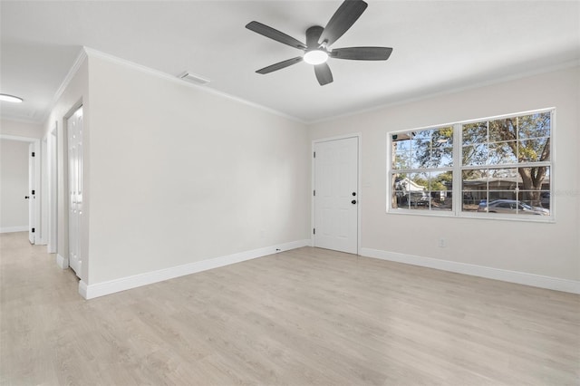 spare room featuring ceiling fan, ornamental molding, and light wood-type flooring