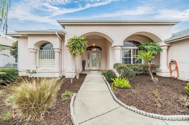 doorway to property featuring stucco siding