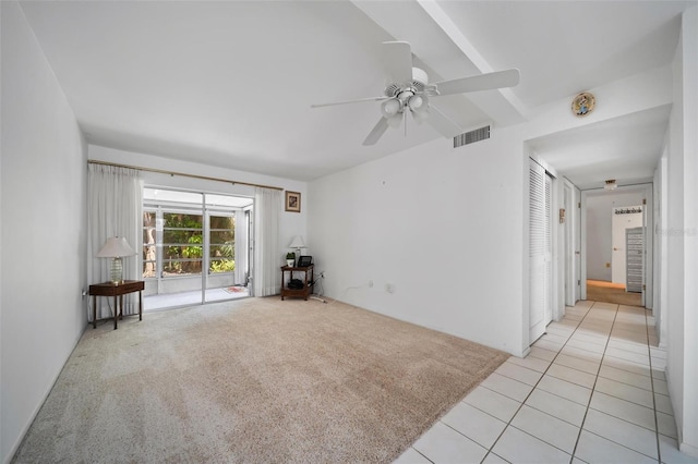 2113 Canal Dr Unit B2, Bradenton, FL 34207 - empty room with a ceiling fan, light tile patterned floors, and light carpet