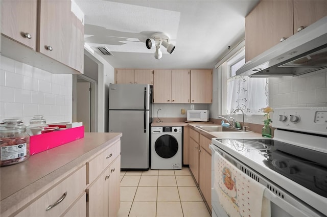2113 Canal Dr Unit B2, Bradenton, FL 34207 - kitchen featuring white appliances, washer / clothes dryer, range hood, light brown cabinets, and decorative backsplash