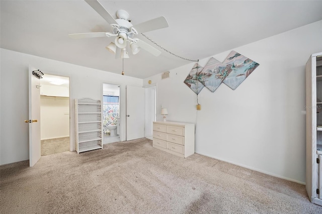2113 Canal Dr Unit B2, Bradenton, FL 34207 - unfurnished bedroom with carpet, a spacious closet, a ceiling fan, and connected bathroom