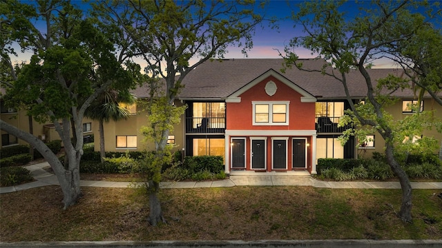 5618 Baywater Dr Unit 5618, Tampa, FL 33615 - multi unit property featuring a lawn, roof with shingles, stucco siding, and a balcony