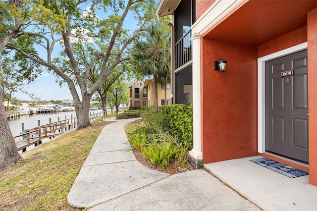 5618 Baywater Dr Unit 5618, Tampa, FL 33615 - doorway to property with a water view, a yard, and stucco siding