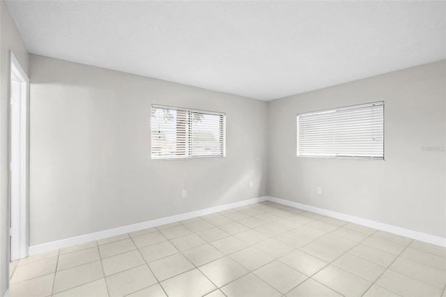5618 Baywater Dr Unit 5618, Tampa, FL 33615 - unfurnished room featuring baseboards and light tile patterned floors