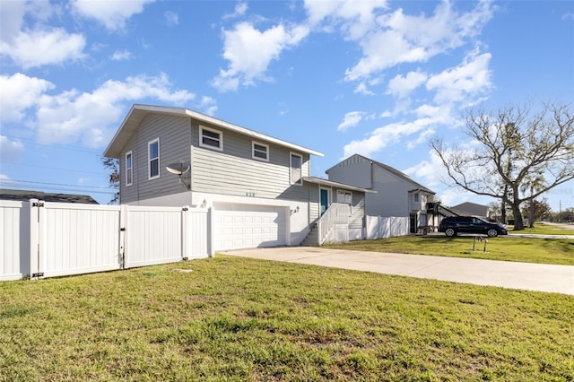 exterior space with a front yard, fence, a garage, and driveway