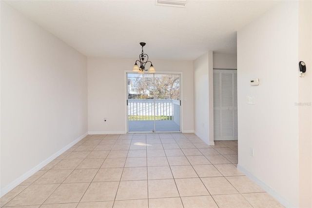 unfurnished room featuring visible vents, baseboards, a chandelier, and light tile patterned flooring