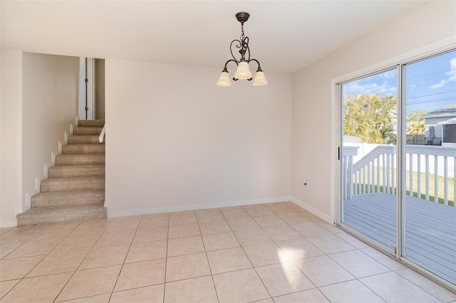 spare room with light tile patterned floors, stairway, baseboards, and an inviting chandelier