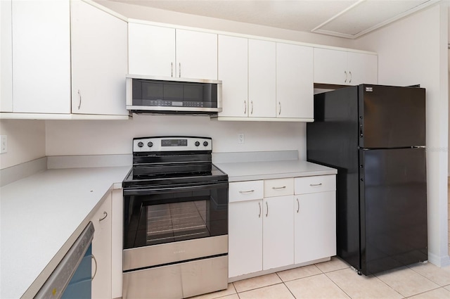 kitchen featuring light tile patterned floors, appliances with stainless steel finishes, white cabinets, and light countertops