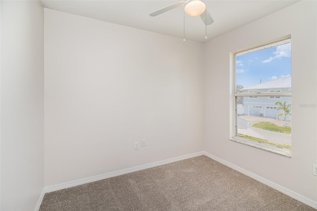 unfurnished room with a ceiling fan, baseboards, and carpet floors