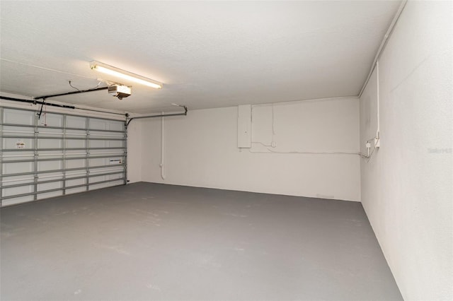 garage featuring electric panel and a garage door opener