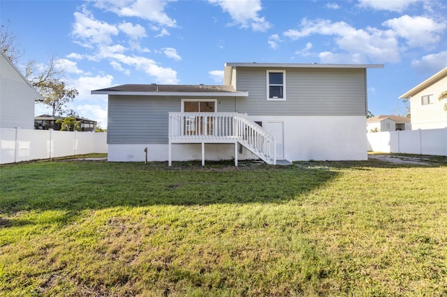 back of property with stairs, a yard, fence, and a wooden deck