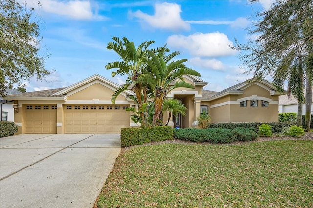 view of front of house with a garage, concrete driveway, a front lawn, and stucco siding