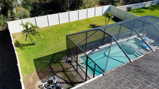 view of pool featuring a fenced in pool, glass enclosure, a lawn, and a fenced backyard