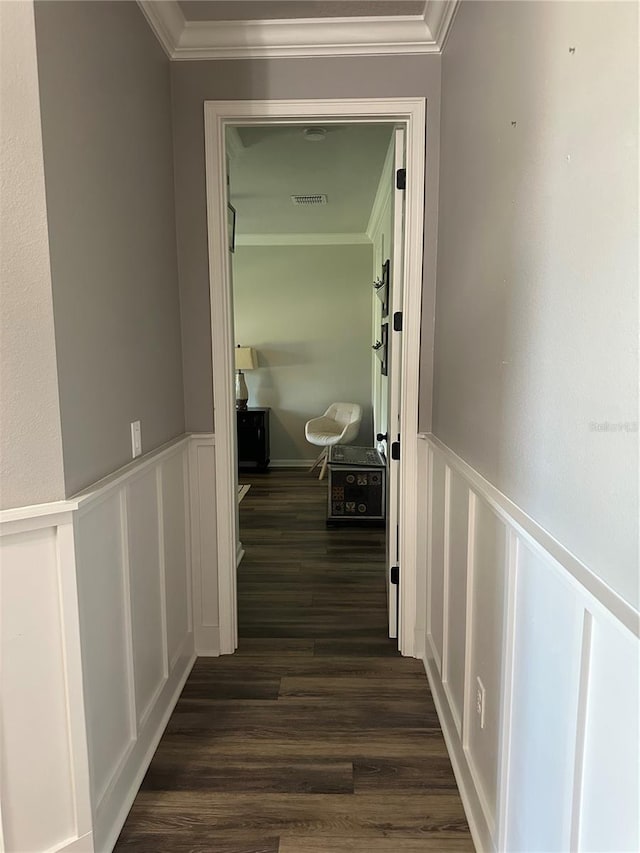 hall featuring visible vents, ornamental molding, dark wood-style flooring, and wainscoting