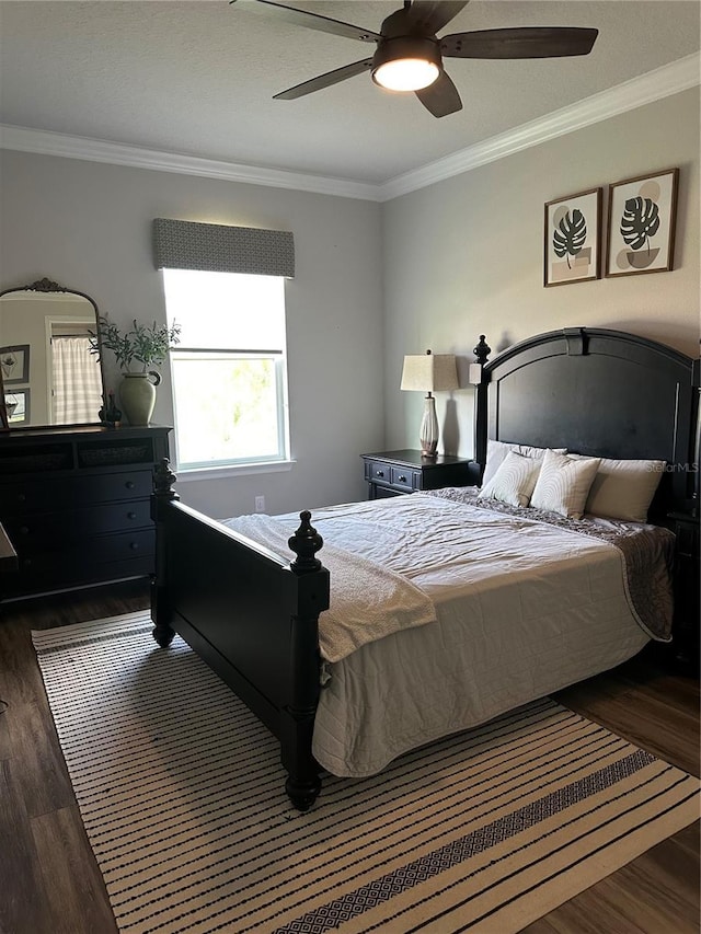 bedroom with dark wood-style floors, ceiling fan, and ornamental molding