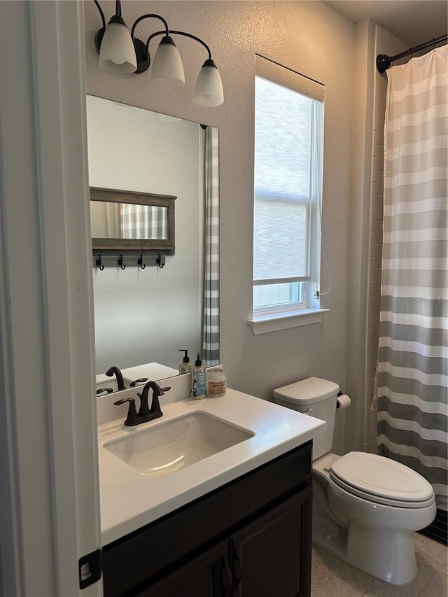 full bathroom featuring vanity and toilet