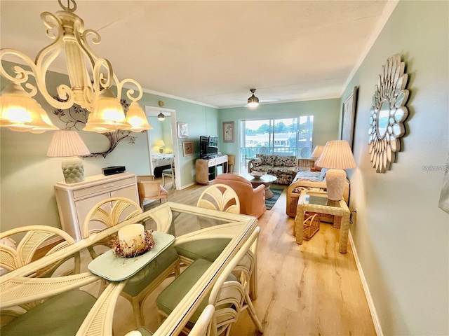 dining area with ceiling fan, crown molding, baseboards, and wood finished floors