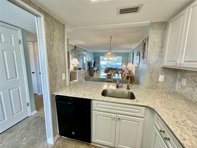 kitchen with black dishwasher, visible vents, backsplash, white cabinetry, and a sink