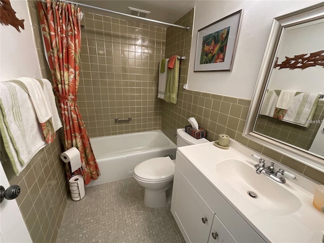 bathroom featuring toilet, vanity, shower / bath combination with curtain, and tile walls