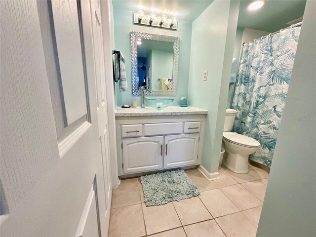 full bathroom featuring baseboards, vanity, toilet, and tile patterned floors