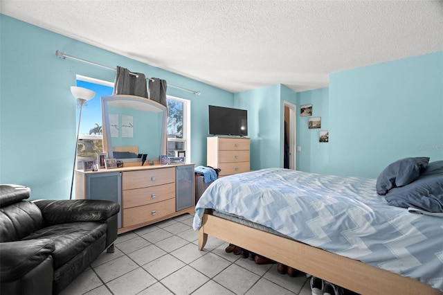 bedroom with a textured ceiling and light tile patterned floors