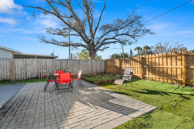 view of patio with a fenced backyard and outdoor dining area