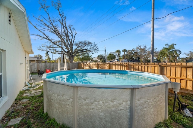 view of swimming pool with a fenced backyard and a fenced in pool