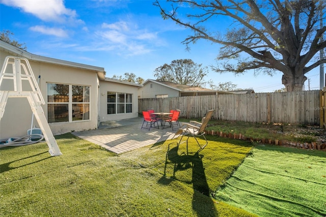 view of yard featuring fence private yard and a patio area