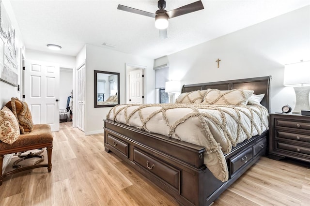 bedroom featuring ceiling fan, light hardwood / wood-style flooring, and a closet