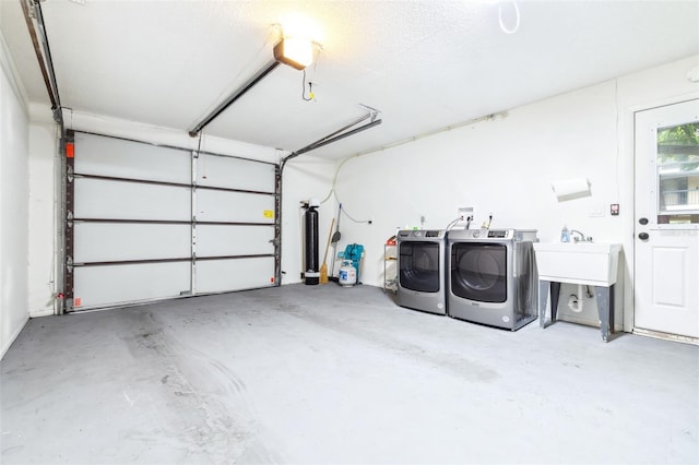 garage featuring sink and washing machine and clothes dryer