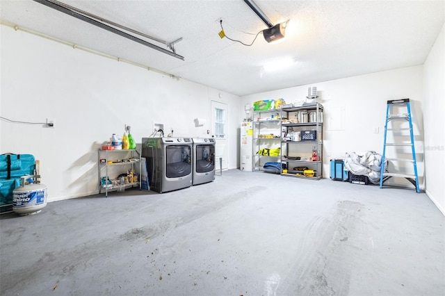 garage featuring washer and dryer, water heater, and a garage door opener