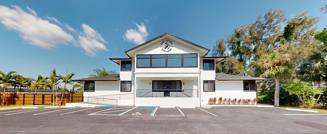 exterior space with uncovered parking and fence