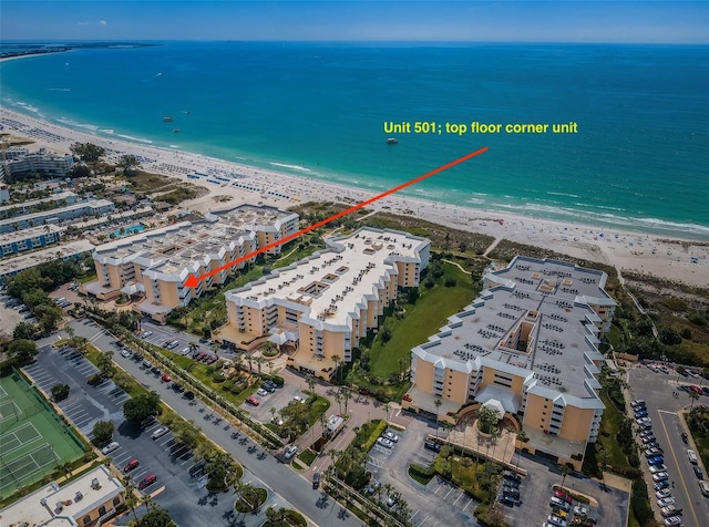 drone / aerial view featuring a beach view and a water view