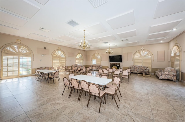 dining room featuring a notable chandelier, visible vents, and coffered ceiling