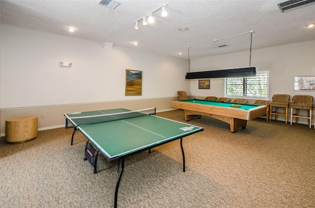 rec room featuring visible vents, carpet flooring, a textured ceiling, and baseboards