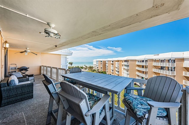 view of patio with ceiling fan and a balcony